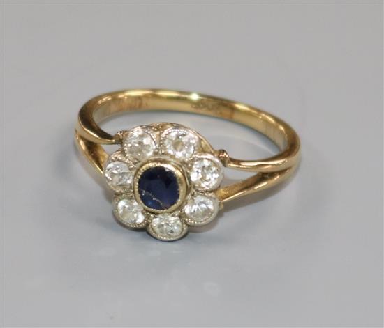 An 18ct gold, sapphire and diamond flower head cluster ring, size N.